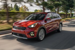 Burnt orange 2022 Kia Niro driving on the road.