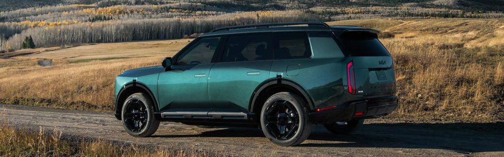 Kia Telluride SUV parked on a scenic mountain landscape.