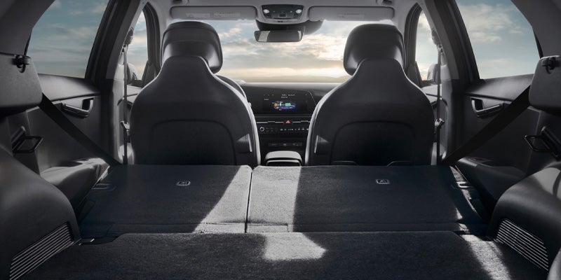 Folded rear seats showing a spacious vehicle cargo area and interior storage space